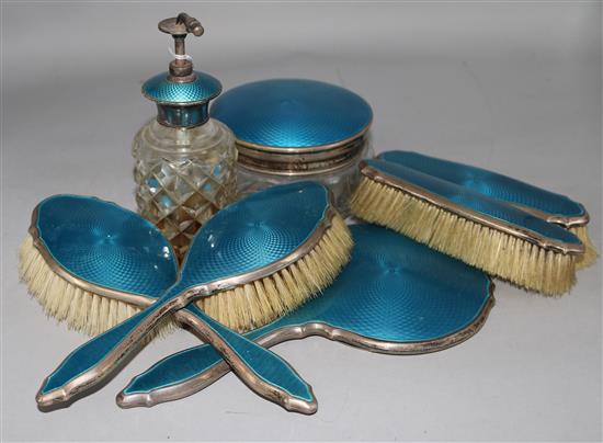 A 1920s seven piece silver and blue guilloche enamel dressing table set.